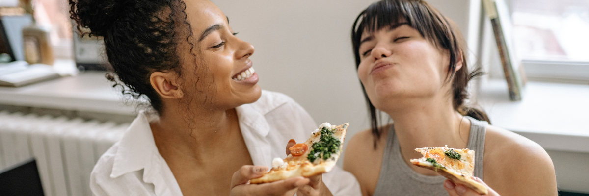Mindful eating, two women eating pizza slices
